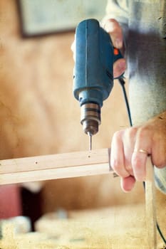 Man's arms drill lath in the workshop - vintage photo
