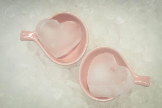 Couple ice hearts on ice texture background