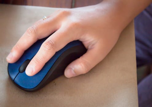 Asian hand hold on controlling computer wireless mouse