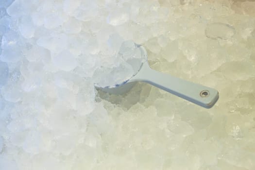 Ice spoon in fresh cool ice background