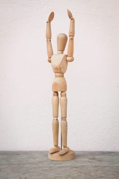 Raising hands up and standing wooden poser