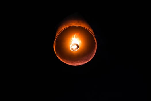 Single floating paper lantern during festival in Thailand