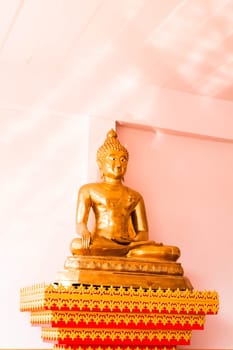 Sitting bronze buddha image statue inside of monk school room