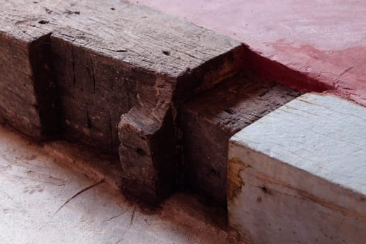 Wooden step on red concrete floor