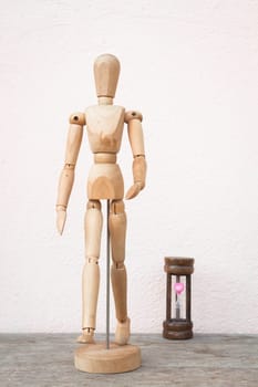 Wooden mannequin pose in concept of progress time