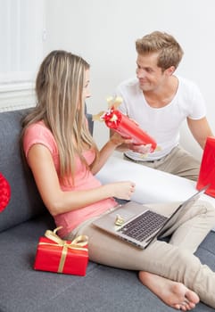 Happy couple exchanging gifts for the special occasion