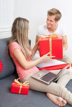 Happy couple exchanging gifts for the special occasion