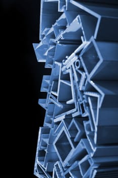many different aluminium profile strips in blue spotlight