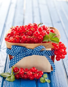 Small basket full of fresh red currants