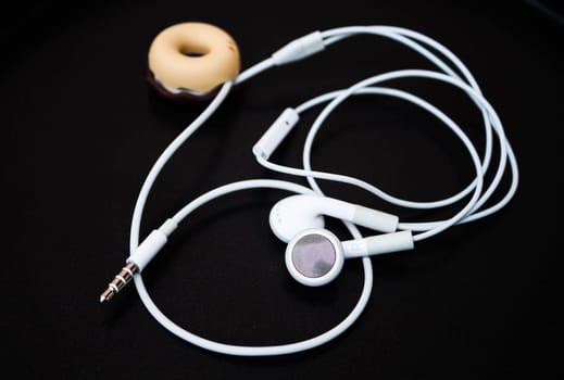 White ear buds and line store isolated on dark background