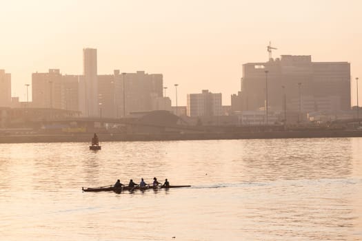 Regatta rowing crews eights quads doubles skulls on race course silhouetted on morning sunrise colors on sea waters at Durban Rowiing Club Head of the Bay Regatta July 12th 2014 Durban South-Africa