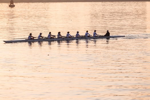 Regatta rowing crews eights quads doubles skulls on race course silhouetted on morning sunrise colors on sea waters at Durban Rowiing Club Head of the Bay Regatta July 12th 2014 Durban South-Africa