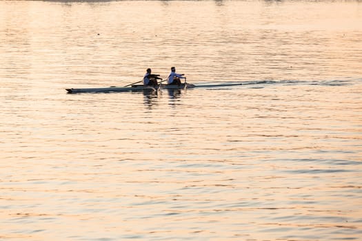 Regatta rowing crews eights quads doubles skulls on race course silhouetted on morning sunrise colors on sea waters at Durban Rowiing Club Head of the Bay Regatta July 12th 2014 Durban South-Africa