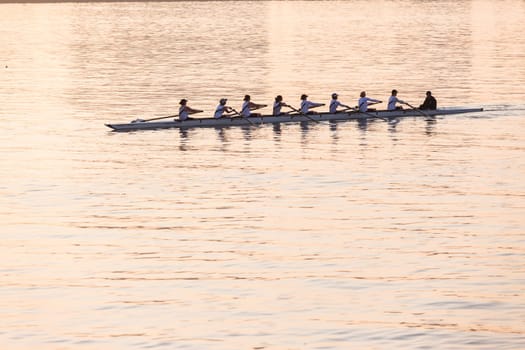 Regatta rowing crews eights quads doubles skulls on race course silhouetted on morning sunrise colors on sea waters at Durban Rowiing Club Head of the Bay Regatta July 12th 2014 Durban South-Africa