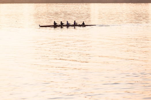 Regatta rowing crews eights quads doubles skulls on race course silhouetted on morning sunrise colors on sea waters at Durban Rowiing Club Head of the Bay Regatta July 12th 2014 Durban South-Africa