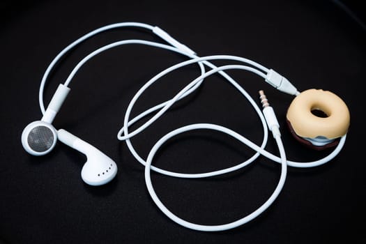 White earphones with line store isolated on dark background