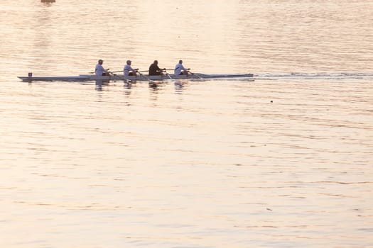 Regatta rowing crews eights quads doubles skulls on race course silhouetted on morning sunrise colors on sea waters at Durban Rowiing Club Head of the Bay Regatta July 12th 2014 Durban South-Africa