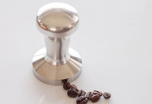 Espresso tamper made from stainless steel on clean table