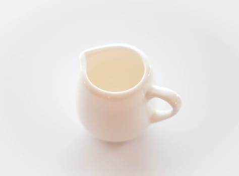 Empty white ceramic pitcher on clean table