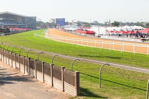Horse racing action of jockeys races at Greyville racecouse sand and grass for Durban July vodacom cup.