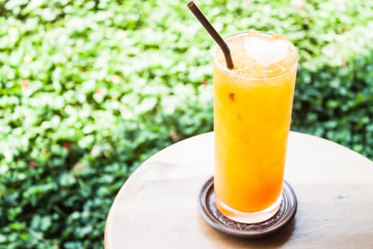 A glass of fresh iced orange juice