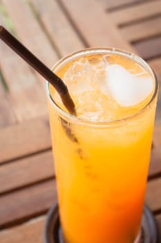 A glass of fresh orange juice on wood table
