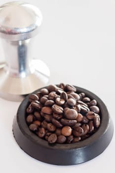Middle roasted coffee bean in rubber saucer