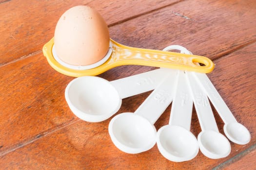Bakery preparing with egg, yolk separator and spoon