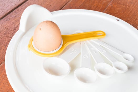Bakery preparing with egg, yolk separator and spoon