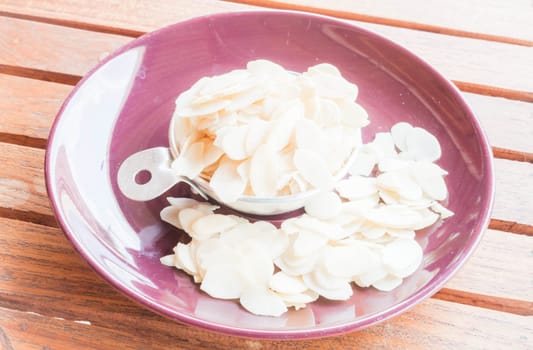 Bakery raw sliced almonds in measured cup
