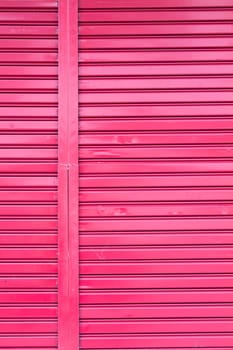 Red roller metal entry door of apartment