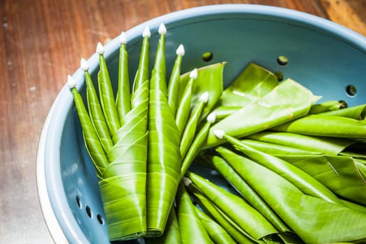 Handmade banana leaf rice offering on wood table