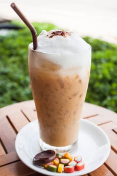 Refreshing glass of cold espresso and some sweet