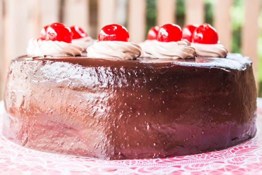 Home made chocolate cake topped with cherry