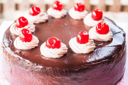 Chocolate cake with cherry and whipped cream
