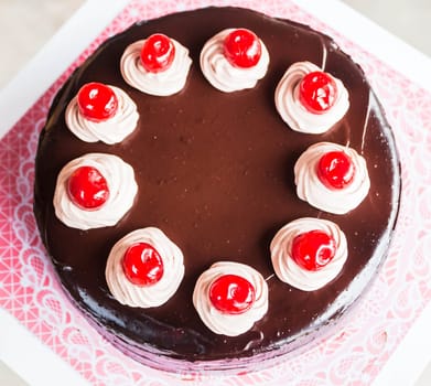 Chocolate cake with whipped cream and cherry