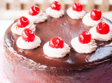 Chocolate whipped cream and red cherry on top
