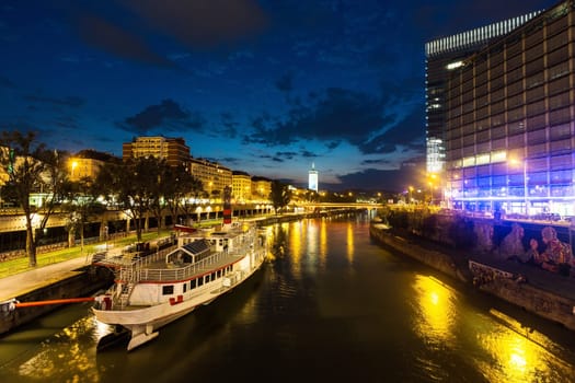 Vienna Danube Canal,cityscape in the evening with a steamship