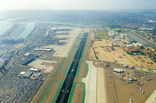 Aerial view of the San Diego International Airport, river and pacific ocean, in Southern California. Lindbergh Field is the busiest single runway commercial airport in the United States of America.
