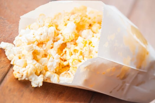 Popcorn packet opened with corn spilling out