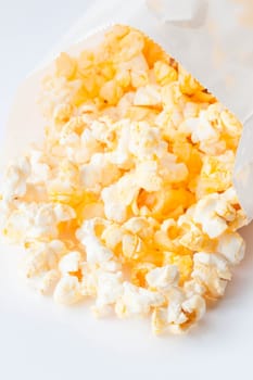 Fresh butter popcorn falling out of paper pack