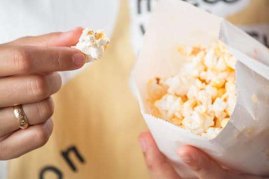 Close up eating butter popcorn from popcorn pack