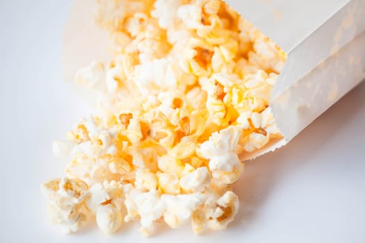 Fresh butter popcorn falling out of the bag