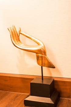 Gold wood carved hand sculpture decorate on table