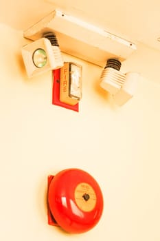 Red fire alarm bell on the wall