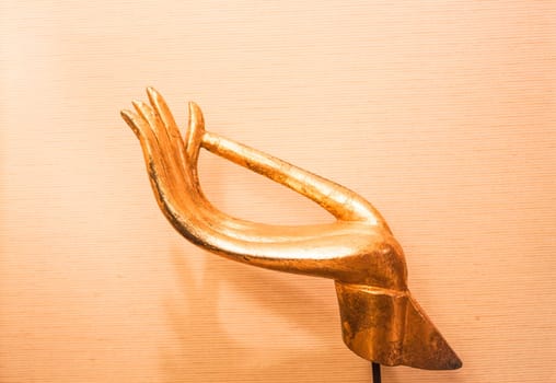 Close up gold hand of wood carved sculpture