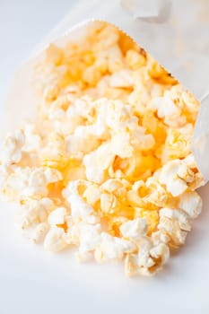 Fresh butter popcorn falling out of paper packet