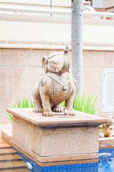 Elephant sculpture decorated beside tropical swimming pool