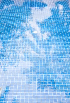 Swimming pool with coconut shade reflection on water