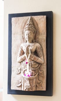Benign stone sculpture of angel decorated wall
